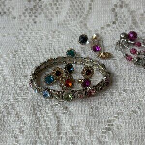 Multicolored pastel colored rhinestone bracelet with 7 pr post earrings.